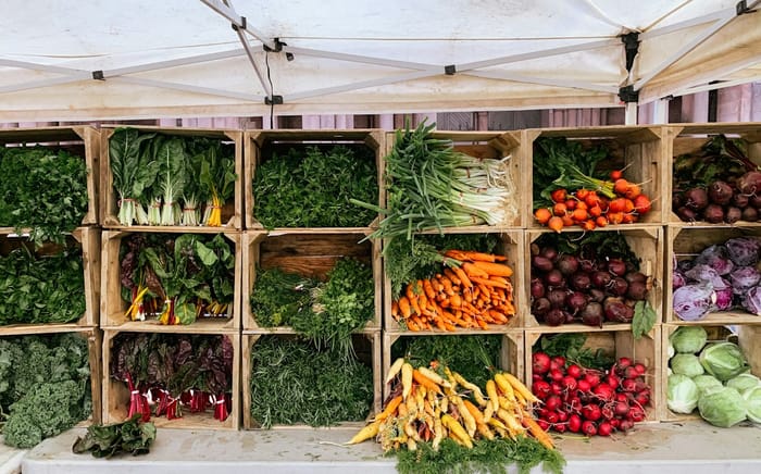 Wooden crates of fresh produce at a farm stand